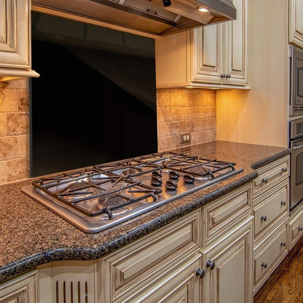 Black glass splashback 50x60cm installed behind gas cooker in a traditional kitchen.