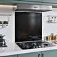 Black stainless steel splashback 60x55cm installed behind cooker in modern kitchen.