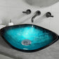 A modern blue glass basin with a shimmering finish, mounted on a bathroom countertop with wall-mounted black faucets.