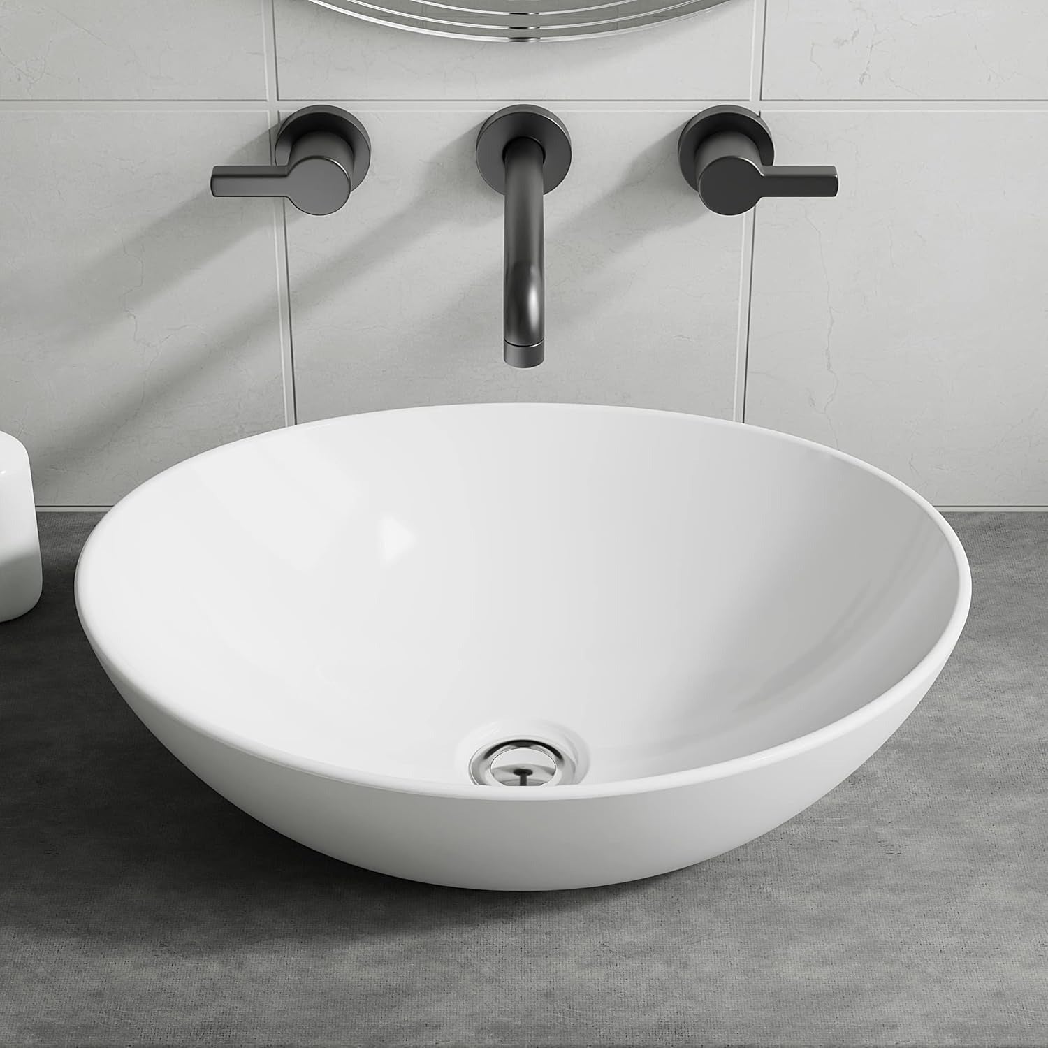 Gloss white oval counter top basin on a grey vanity with wall-mounted black tap.