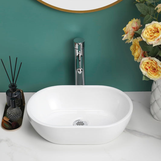 Gloss white oval counter top basin with a chrome tap on a green wall background.