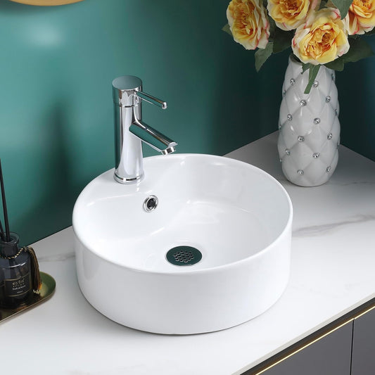 Gloss white round counter top basin on a white vanity with a chrome tap and green wall.