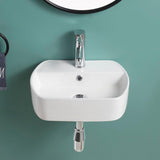 Gloss white wall hung basin with a sleek modern design, installed against a green wall with a chrome tap.