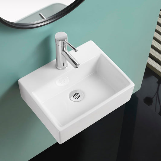 Gloss white wall-hung square basin with chrome tap and waste, mounted on a teal wall.