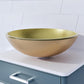 Close-up of gold glass basin on a white countertop in bathroom.