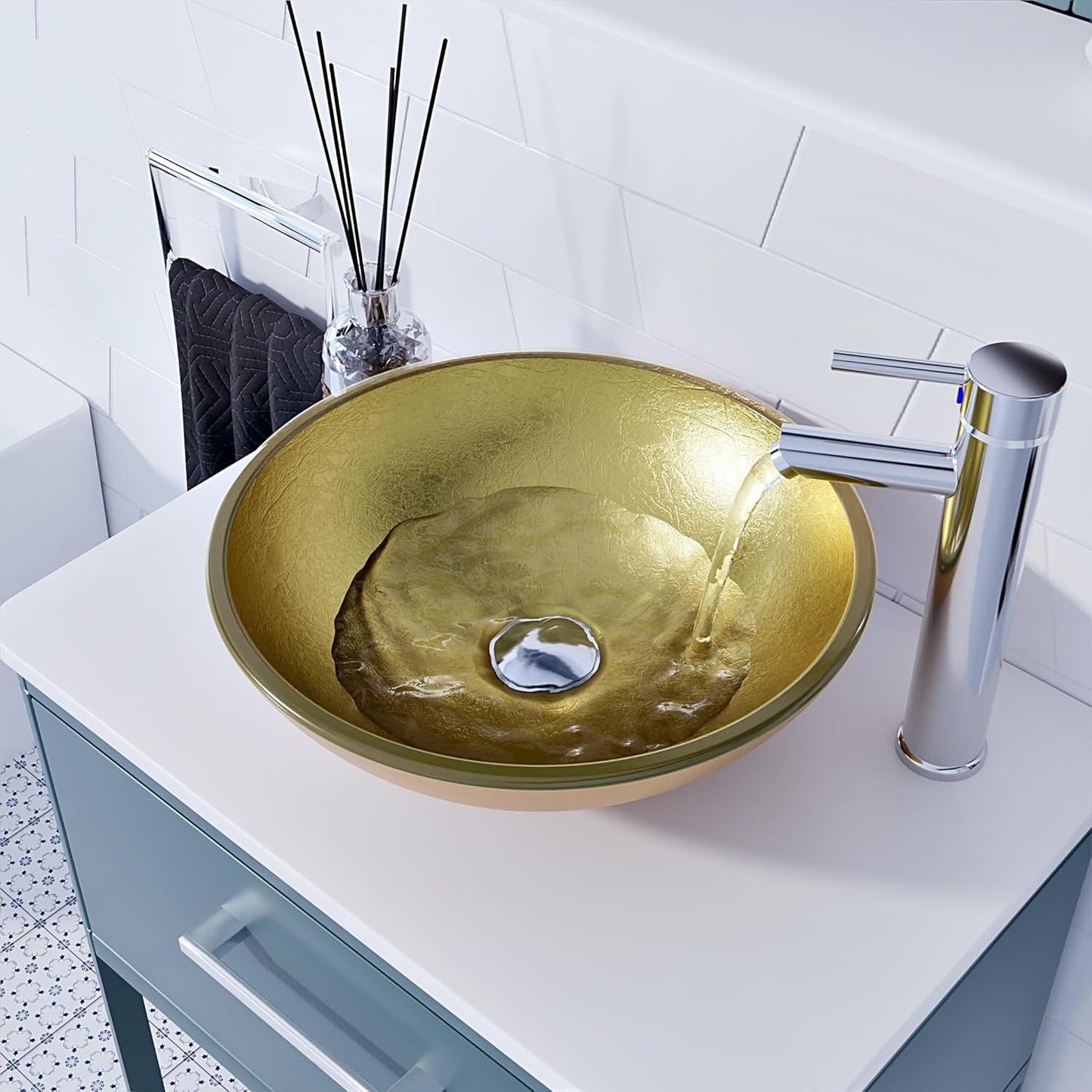 Gold glass basin with water flowing from chrome faucet on countertop.