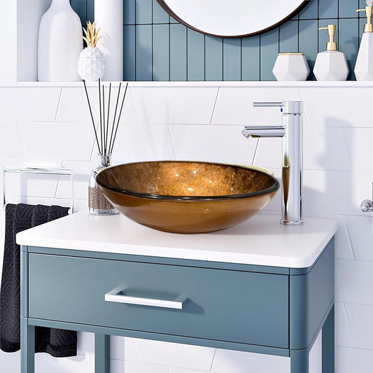 Gold glass basin paired with a chrome faucet and drain set, displayed on a white vanity in a stylish bathroom setting.