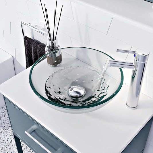 Modern glass basin with round countertop sink and chrome faucet, perfect for vanities and stylish bathrooms.