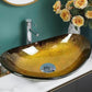 Oval gold glass basin with faucet on marble countertop in modern bathroom.