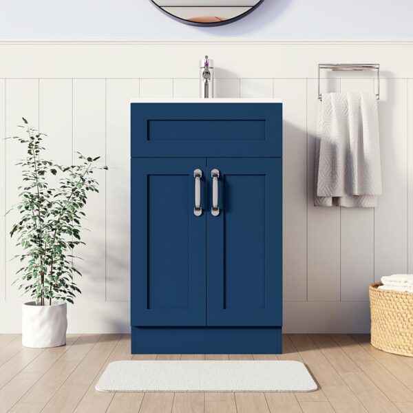 500mm blue vanity unit with white basin and chrome tap, standing next to a plant in a bright bathroom setting.